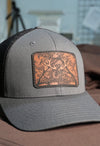 Gray cap with a leather patch featuring 'TWC Mechanical Ltd' on a blurred background